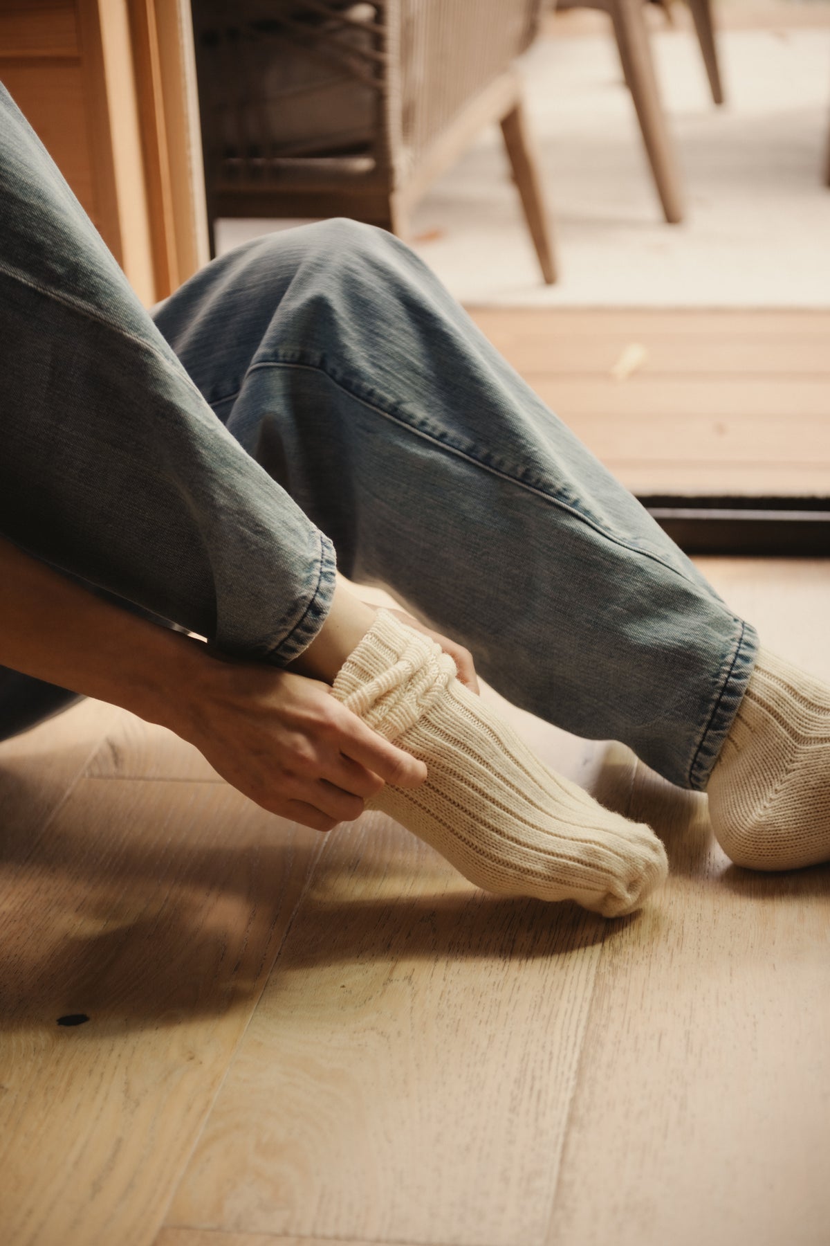 Natural merino crew socks with ribbed legs, worn with jeans