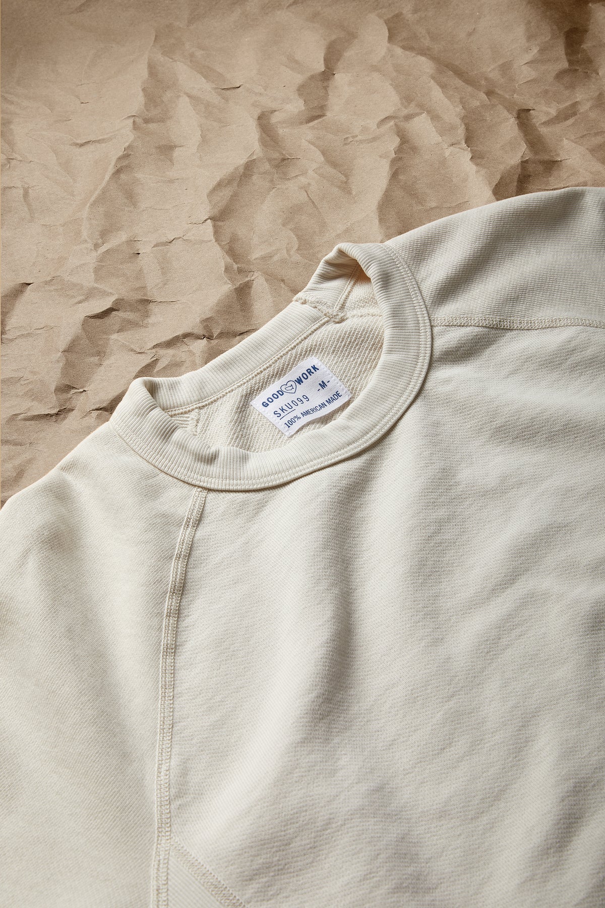 Off-white crew neck terry sweatshirt close-up of neckline label and stitching