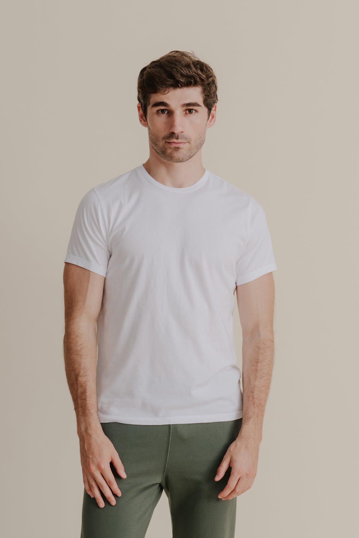 Men's short sleeve crew tee, white, worn by a model facing forward.